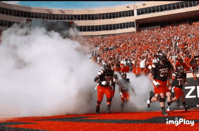 Football Player Number 27 Runs Out Of Tunnel GIF