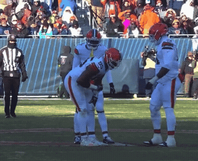 Football Player Number 28 Talking To Another Player GIF