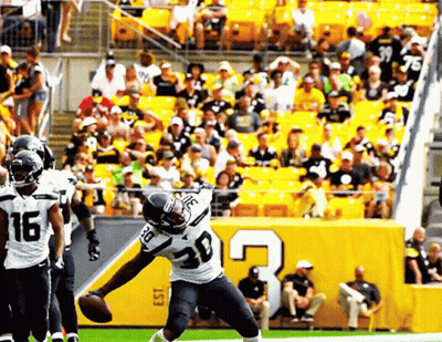 Football Player Number 30 Throws Ball