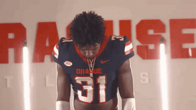 Football Player Number 31 In Front Of Wall Saying Raise GIF