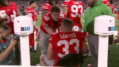 Football Player Number 33 Being Helped On Field GIF
