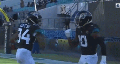 Football Player Number 34 Next To Another Player GIF