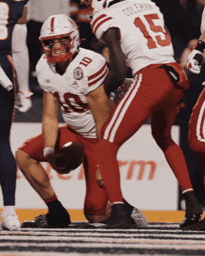Football Player Number 4 Being Helped By Teammate GIF