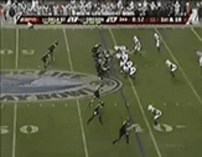 Football Player Number 4 Surrounded By Players GIF