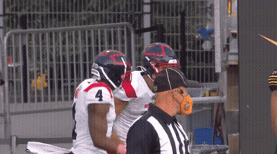 Football Player Number 4 Talking To Another Player GIF