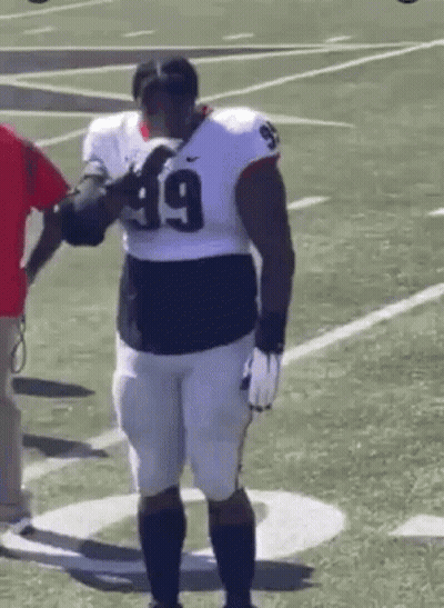 Football Player Number 49 With Man In Red Shirt GIF