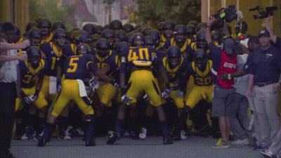 Football Player Number 5 Surrounded By Players GIF