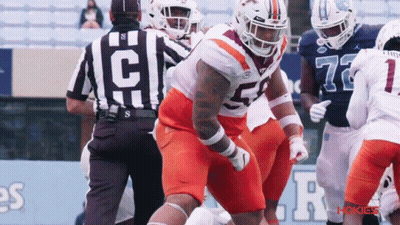 Football Player Number 52 Next To Referee GIF