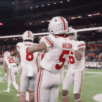 Football Player Number 56 Hugging Teammates GIF