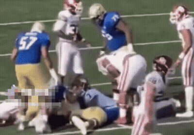 Football Player Number 57 Laying On Field GIF