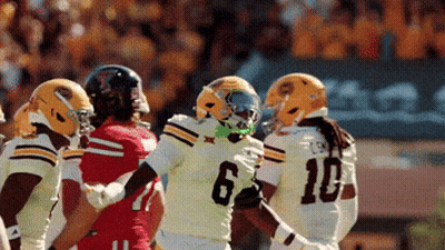 Football Player Number 6 Surrounded By Players GIF