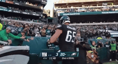 Football Player Number 65 In Front Of Crowd GIF
