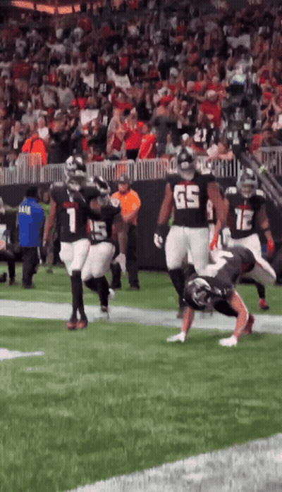 Football Player Number 65 Tackled GIF