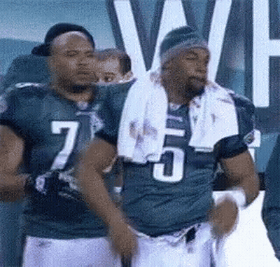 Football Player Number 7 Standing Next To Number 5 GIF
