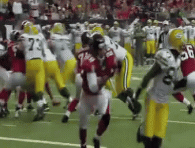 Football Player Number 7 Surrounded By Players GIF