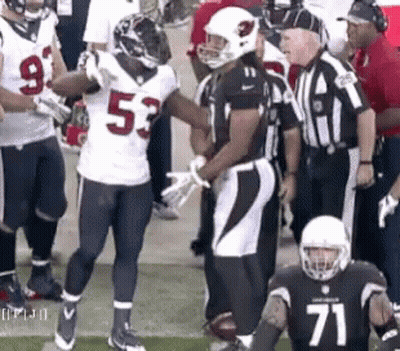 Football Player Number 71 Talking To Another Player GIF
