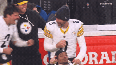 Football Player Number 8 In Front Of Coral Ad GIF