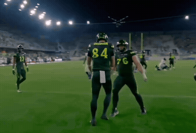 Football Player Number 84 Beside Another Player GIF
