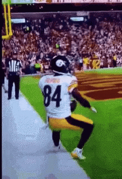 Football Player Number 84 Squatting On Field GIF
