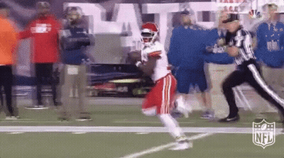 Football Player Running As Referee Looks On GIF