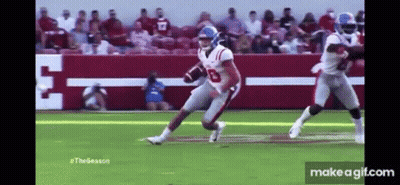 Football Player Running Ball With Tackler GIF