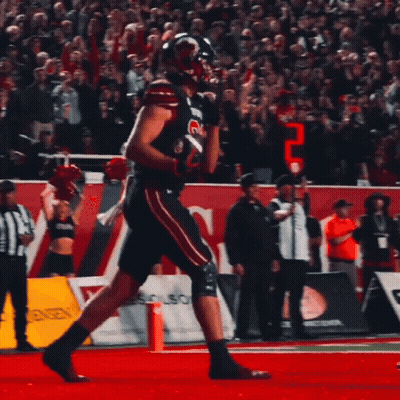 Football Player Running In Front Of Boston Sign GIF