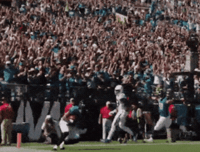 Football Player Running On Field In Front Of Crowd GIF