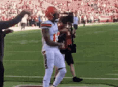 Football Player Running With Cameraman GIF