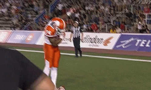 Football Player Running With Referee Behind GIF