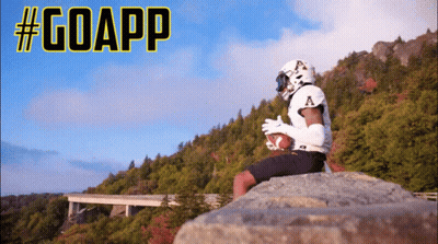 Football Player Sitting On Rock Holding Football #GoApp GIF