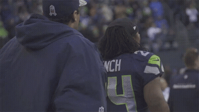 Football Player Smiling Talking To Coach On Field GIF