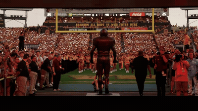 Football Player Statue In Front Of Coca-Cola Ad GIF