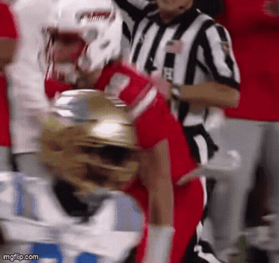 Football Player Tackled With Referee Watching GIF