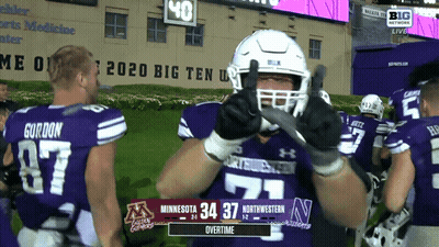 Football Player Thumbs Up In Front Of Big Ten Live Scoreboard GIF