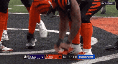 Football Player Tying Shoes On Field GIF