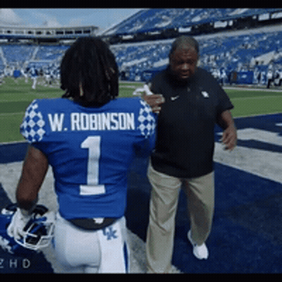 Football Player W Robinson Talking To Coach GIF