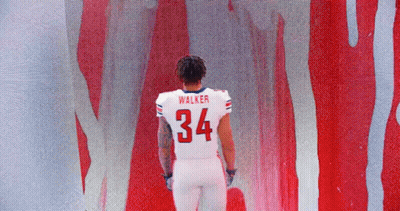 Football Player Walker In Front Of Red Wall GIF
