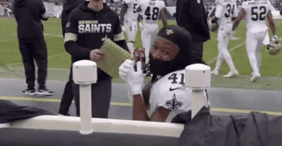 Football Player Wearing Mask Holding Soda GIF