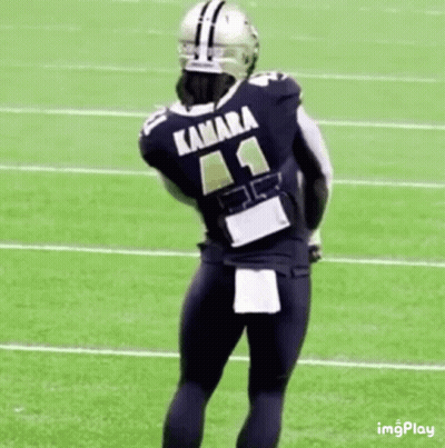 Football Player With Arms Outstretched On Field GIF