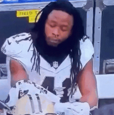Football Player With Dreadlocks Signing Glove GIF