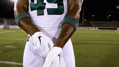 Football Player With H Helmet In Front Of Two Bobcats Logos GIF