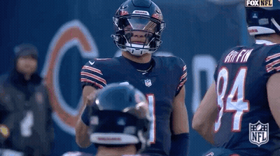 Football Player With Helmet Standing Next To Player GIF