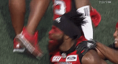 Football Player With Red Face Paint Being Helped Off GIF