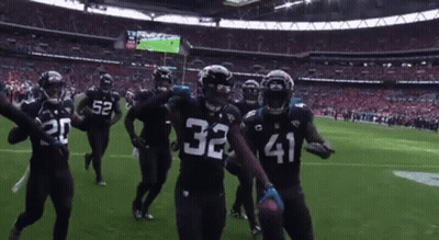 Football Players 32 And 41 Celebrating On Field GIF
