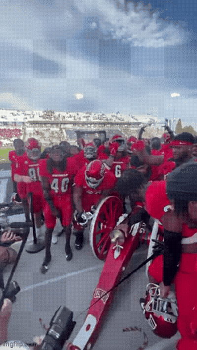 Football Players Around Red Cannon Number 6 GIF
