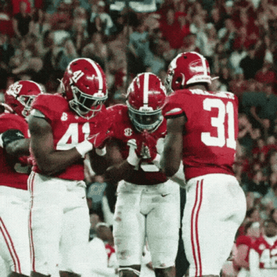 Football Players Dancing In Front Of Man In Suit GIF