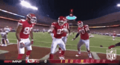 Football Players Dancing On Field With NFL Logo GIF