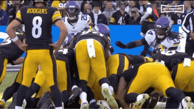 Football Players Huddled Including Rodgers GIF
