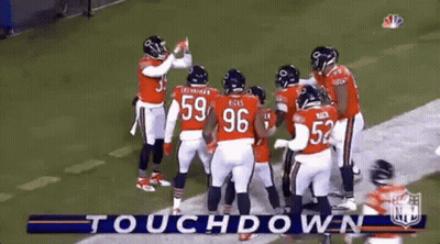 Football Players Huddled Together On Field GIF