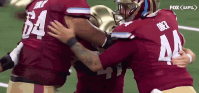 Football Players Hugging On Field GIF
